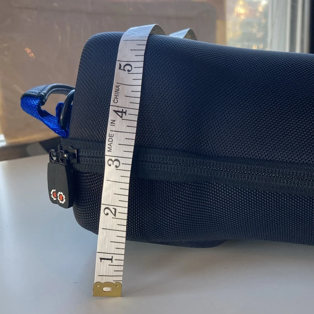 Hard carrying case for long-lens camera with strap